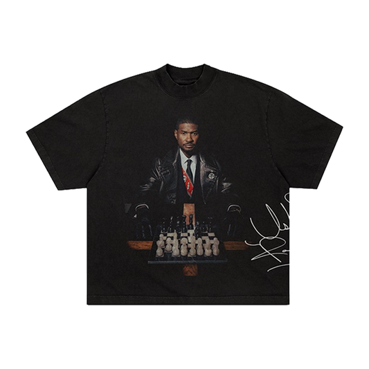 Black t-shirt with a graphic of Usher in a suit and tie, chessboard, and signature 